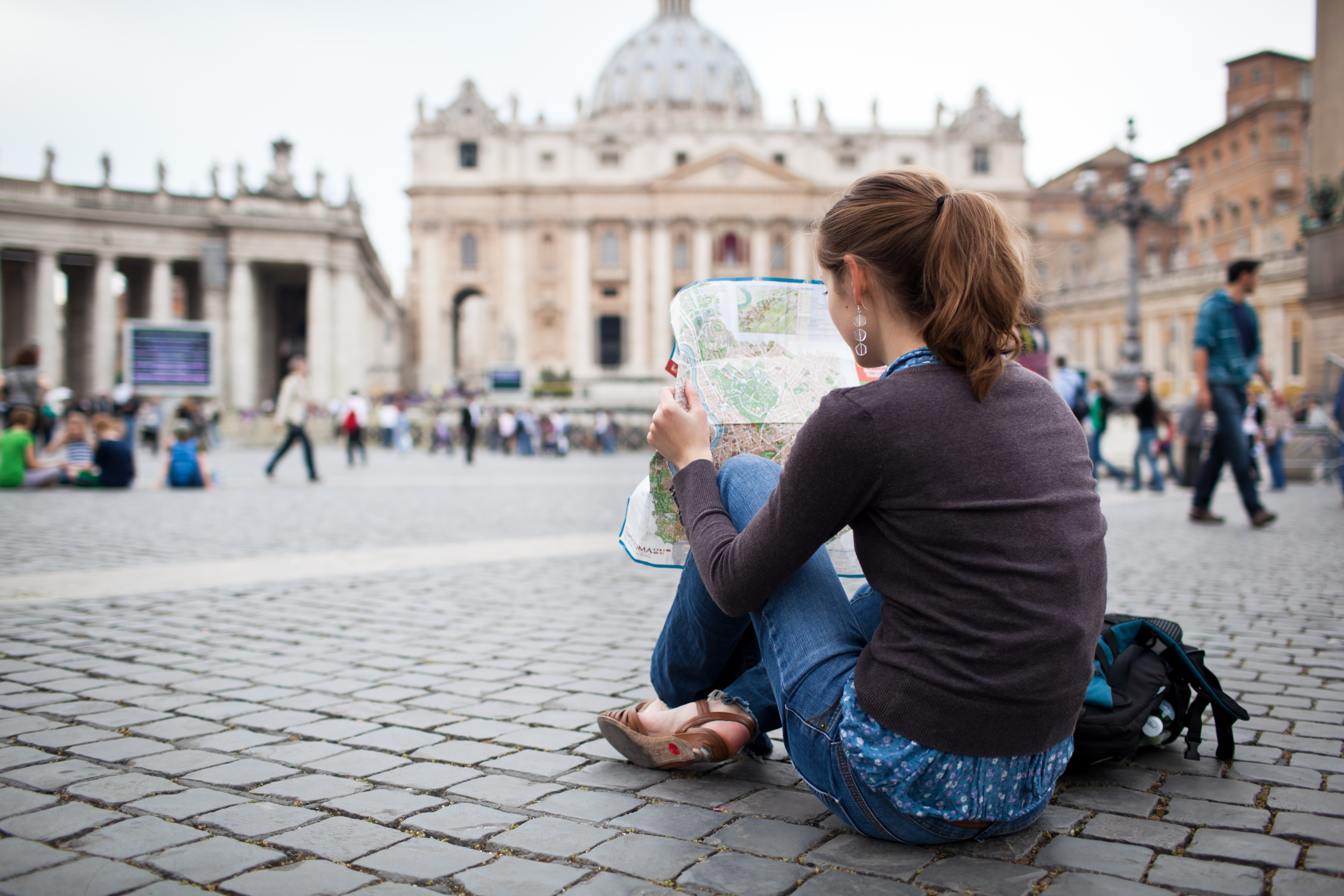 woman sitting in front of St. Peter's Basilica, Vatican Tour